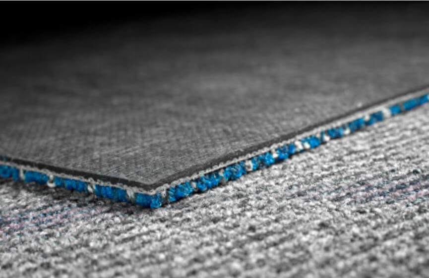 the back of a tufted carpet tile