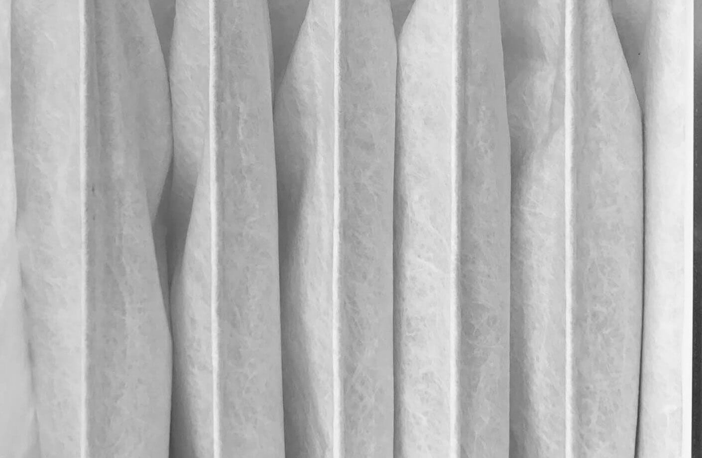 pleats of a filter supported by Colback spunbond non-woven fabric filter media for sharp pleats and bonding with melt-blown layer in HVAC filters